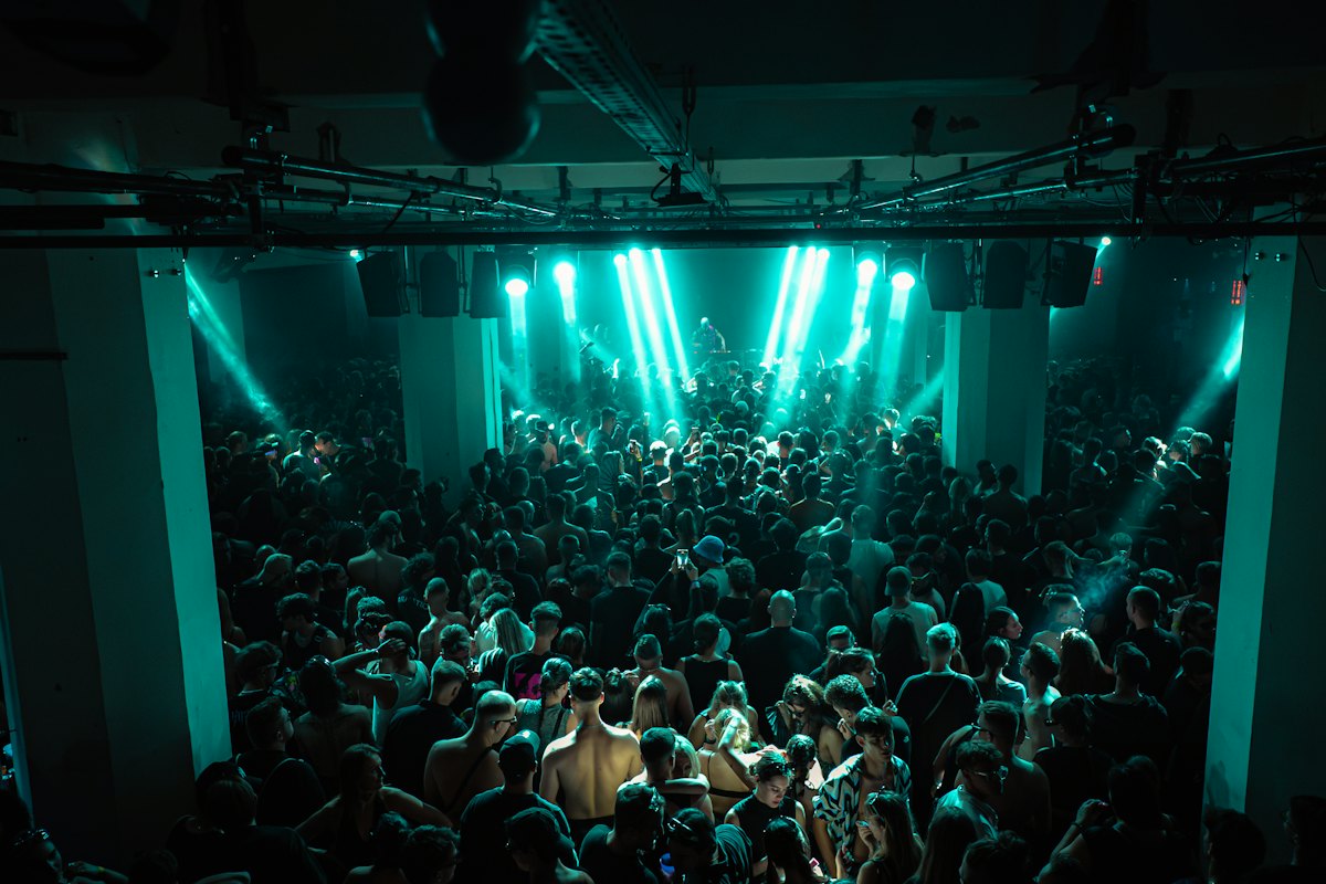 Full club under teal stage lights
