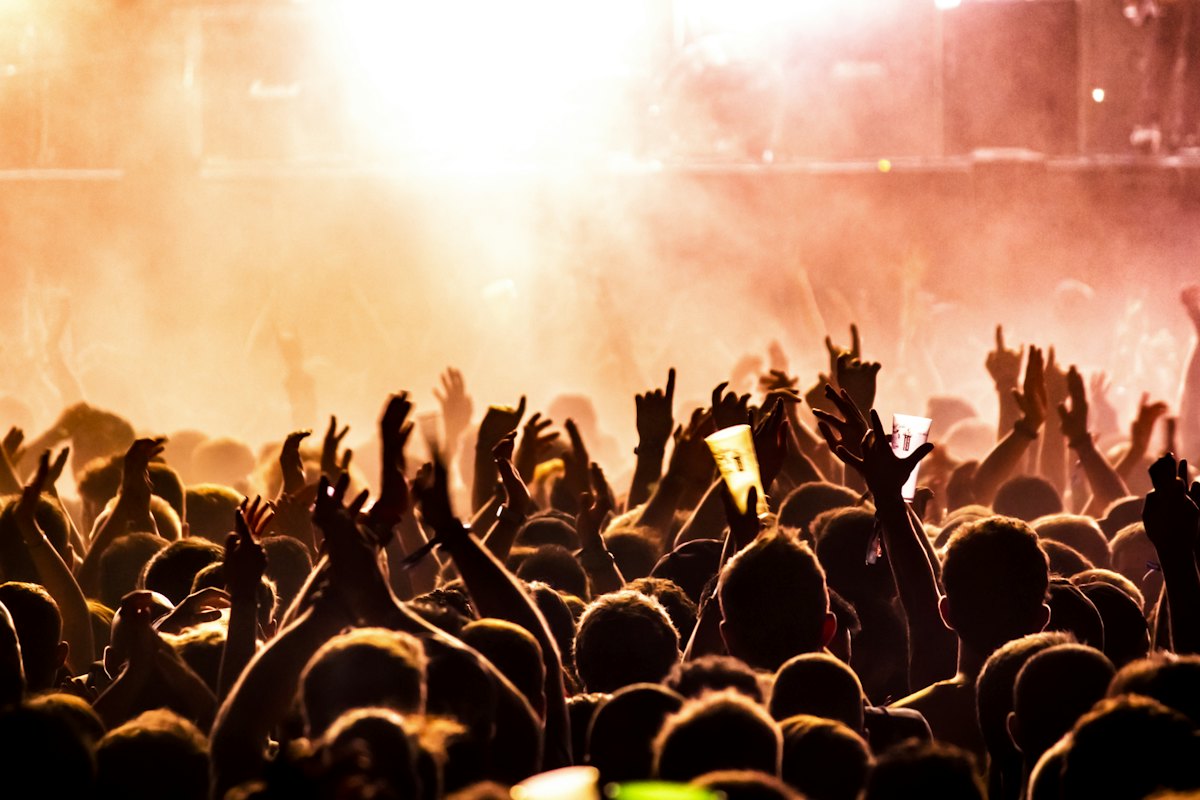 Crowd with hands raised at a sold-out show